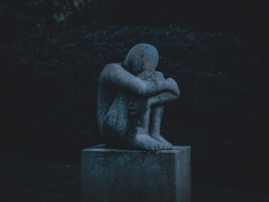 A statue looking sad. Image is part of an article discussing the KPOP song: Yunho’s “Be Alright"