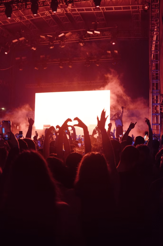 Image of a fan making a heart sign at a concert. Used in an article talking about what it's like to feel that your KPOP bias is underrated.