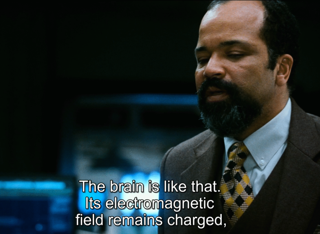 Shot from Source Code (2011): Dr. Rutledge explaining what is source code. 